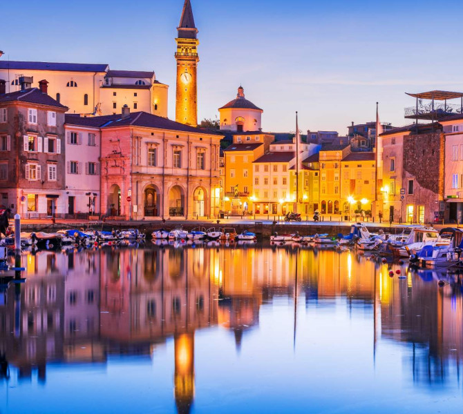 Costal city of Piran at night.