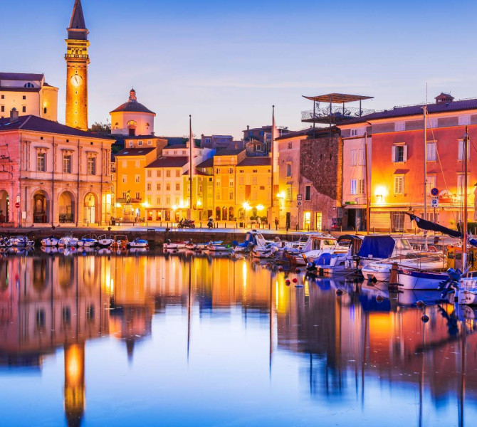 Costal city of Piran at night.