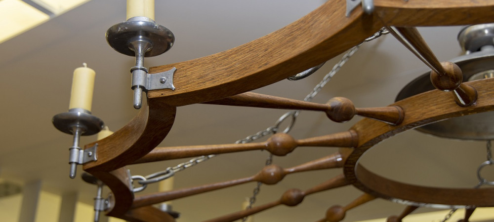 Wooden chandelier with candles.