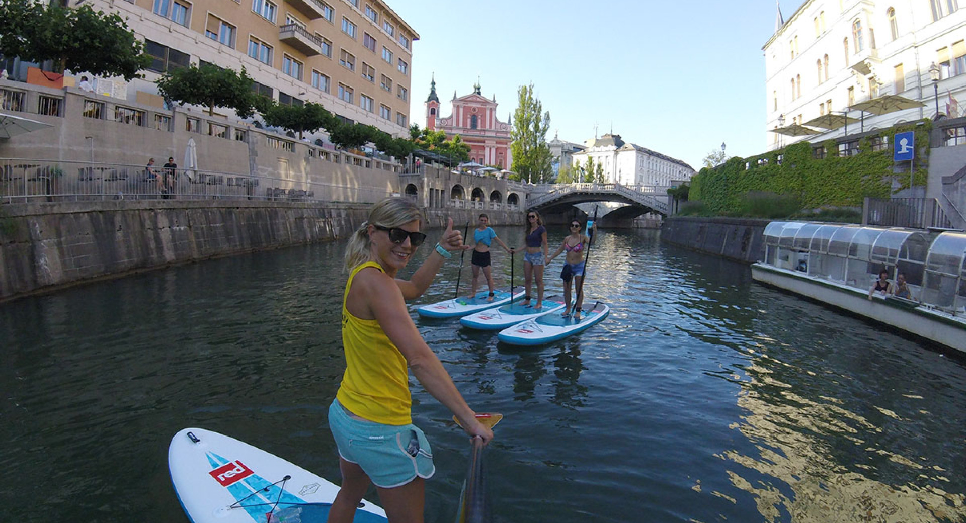  Four paddleboarders on the Ljubljanica River.