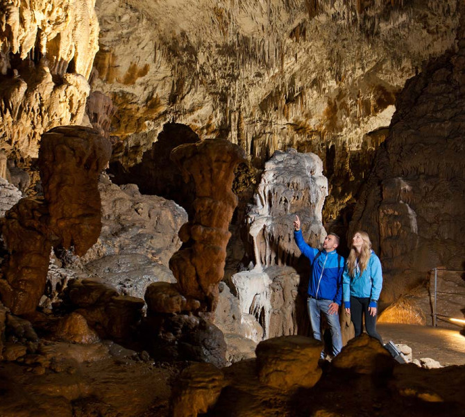 Obiskovalca v jami občudujeta kapnike.