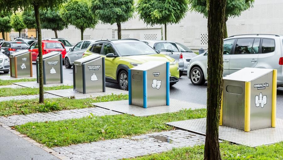 Five garbage bins for waste disposal.