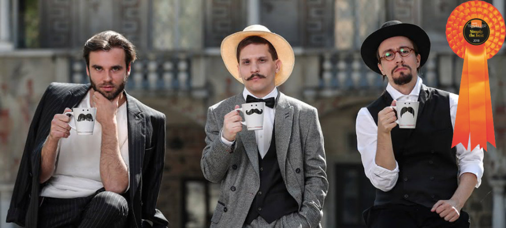 Actors in the roles of Plecnik, Jakopic, and Cankar, holding cups in their hands.