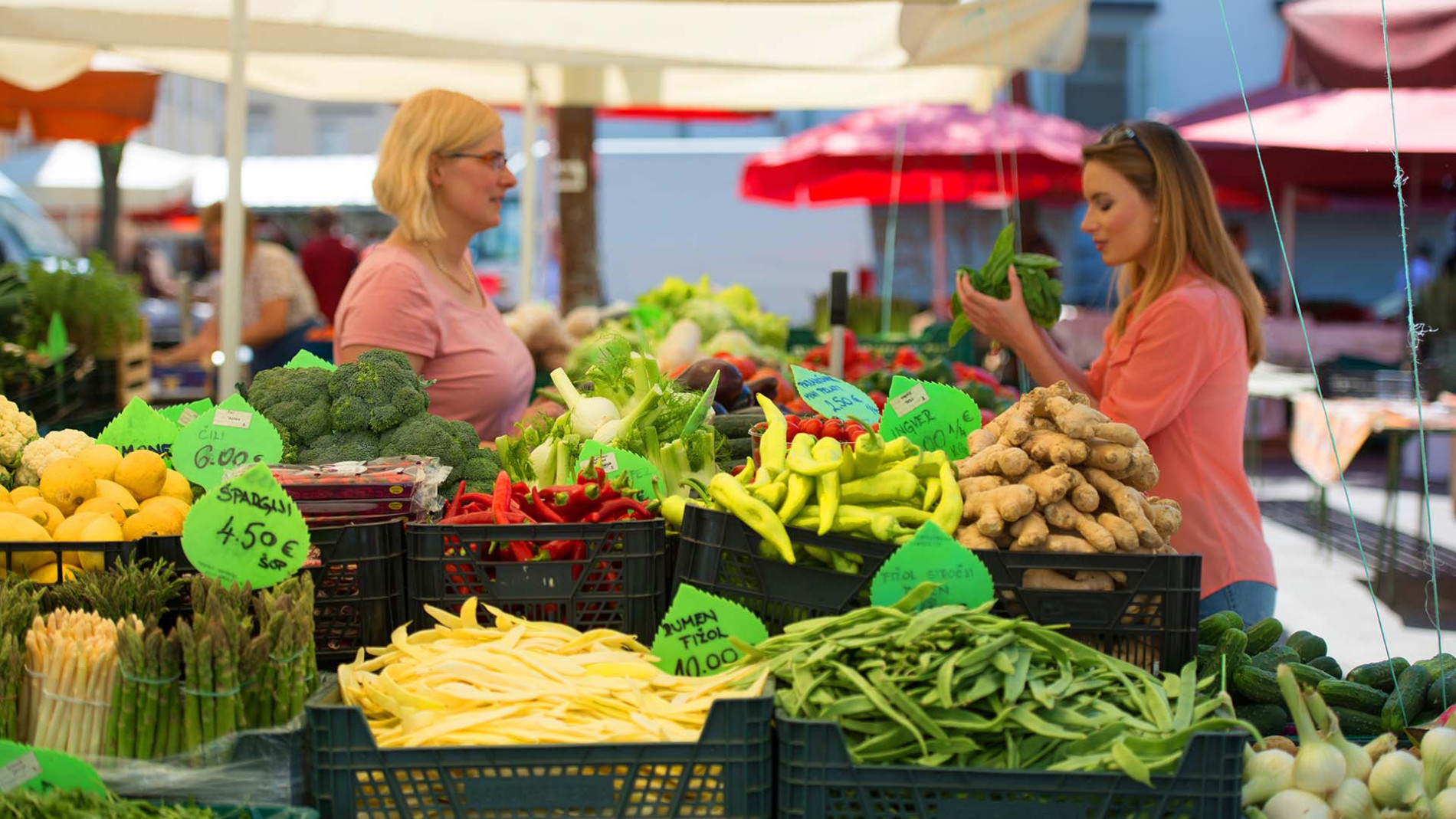 The Central Market in Ljubljana, showing rows of fresh produce and bustling activity.