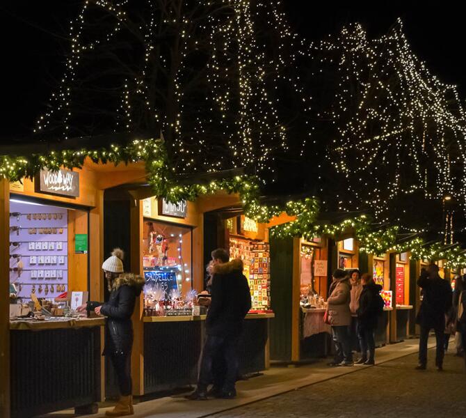 People visiting the stalls at christmas market.