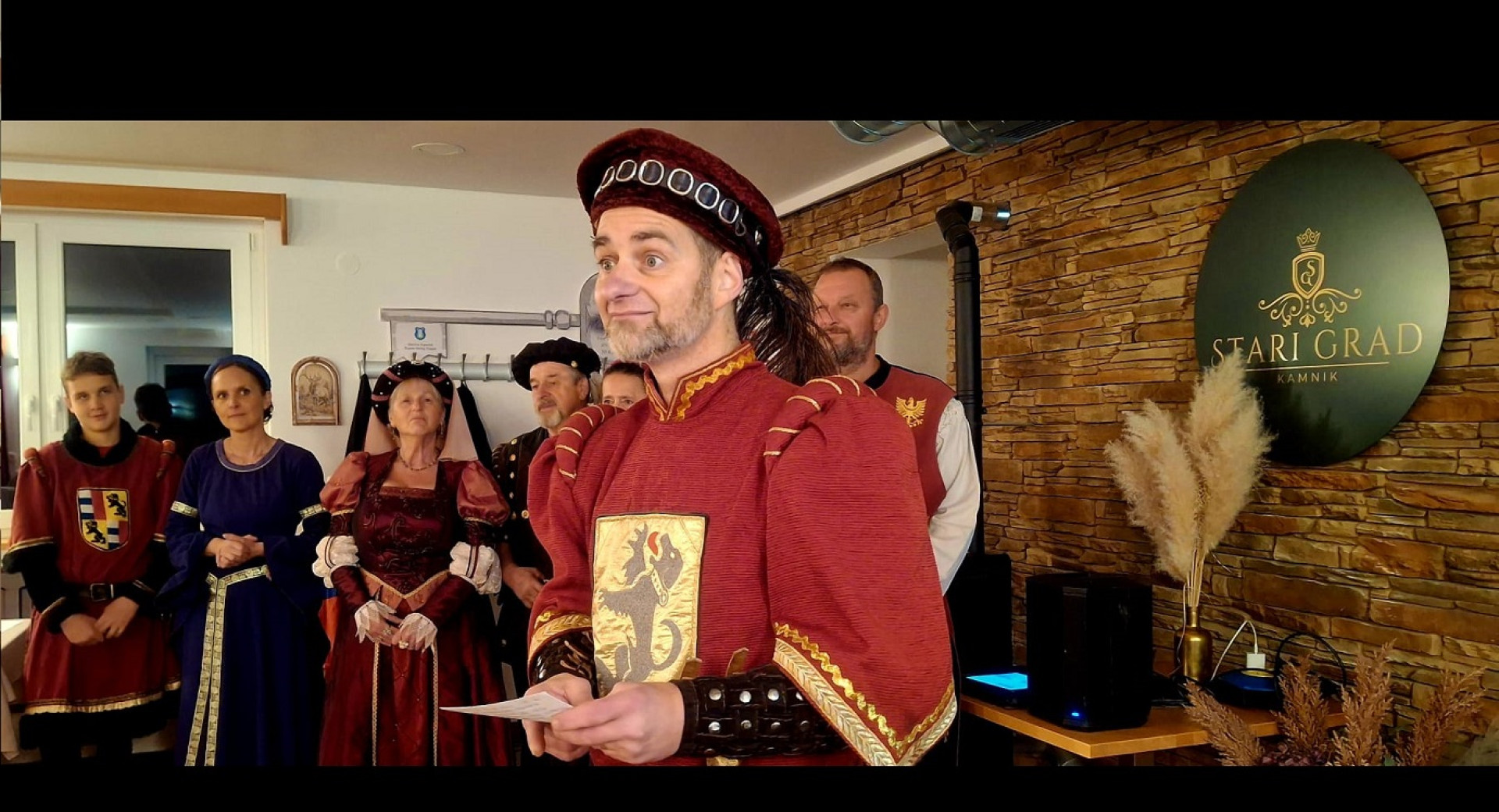 People dressed in red medieval costumes perform at the Old Castle above Kamnik.