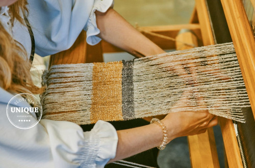Weaving on a loom as part of a craft workshop.
