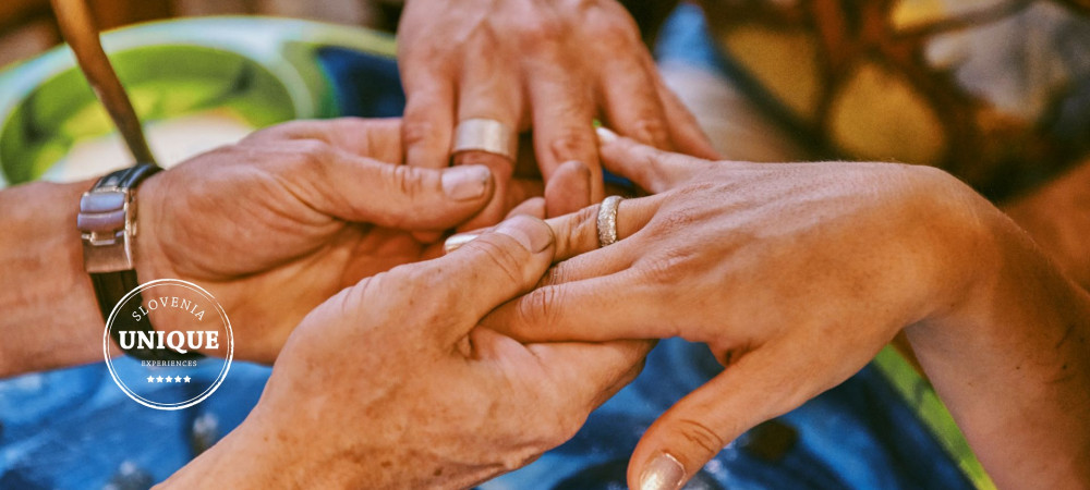 Two pairs of hands with handcrafted rings.