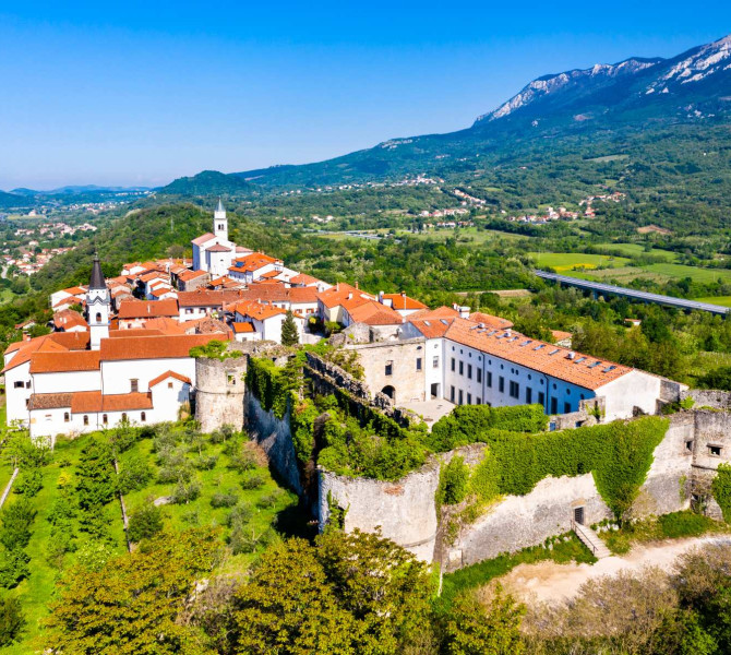 Small stone village surrounded by vineyards.